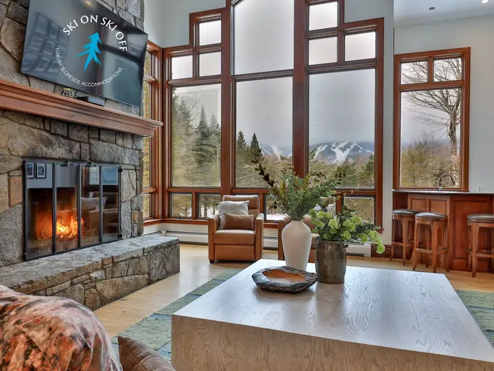 The Mountainside House great room with fireplace and mountain views